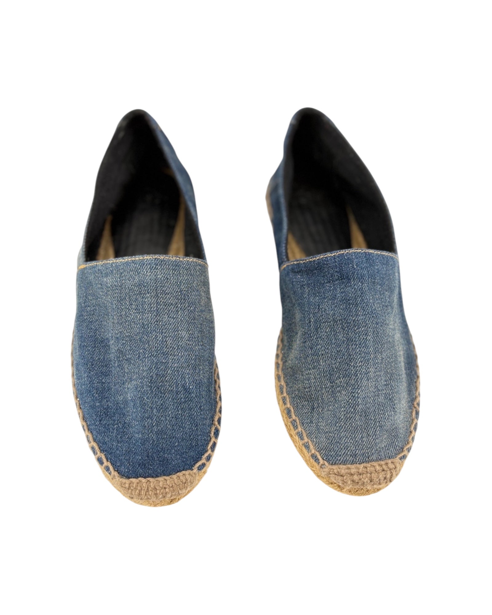 Pair of blue denim espadrilles on a white background