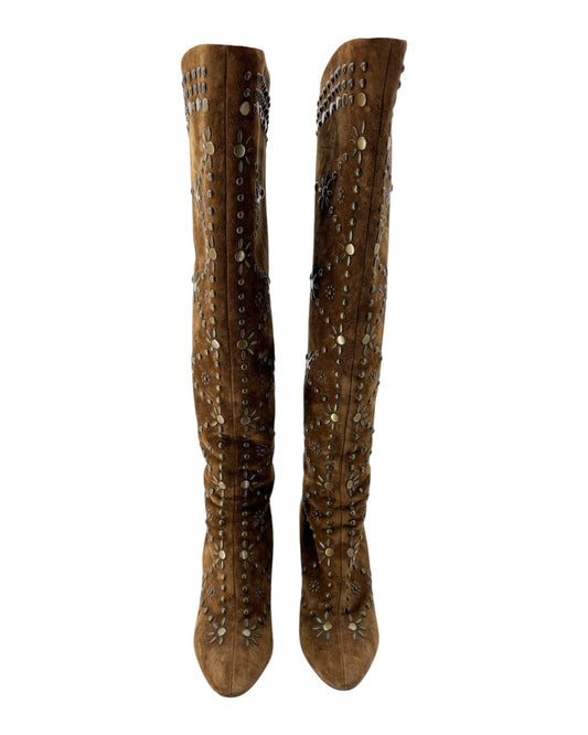 Brown knee-high boots with decorative elements on a white background