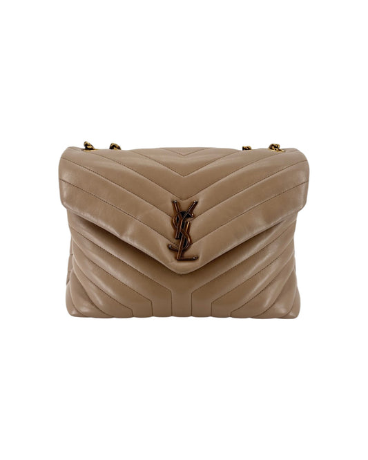 Beige handbag with gold YSL hardware on a white background