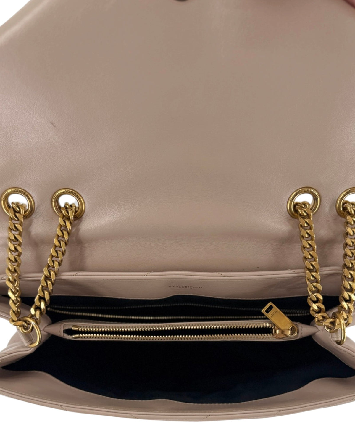 Beige handbag with gold hardware on a white background
