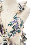 Floral patterned scarf on a mannequin with a white background