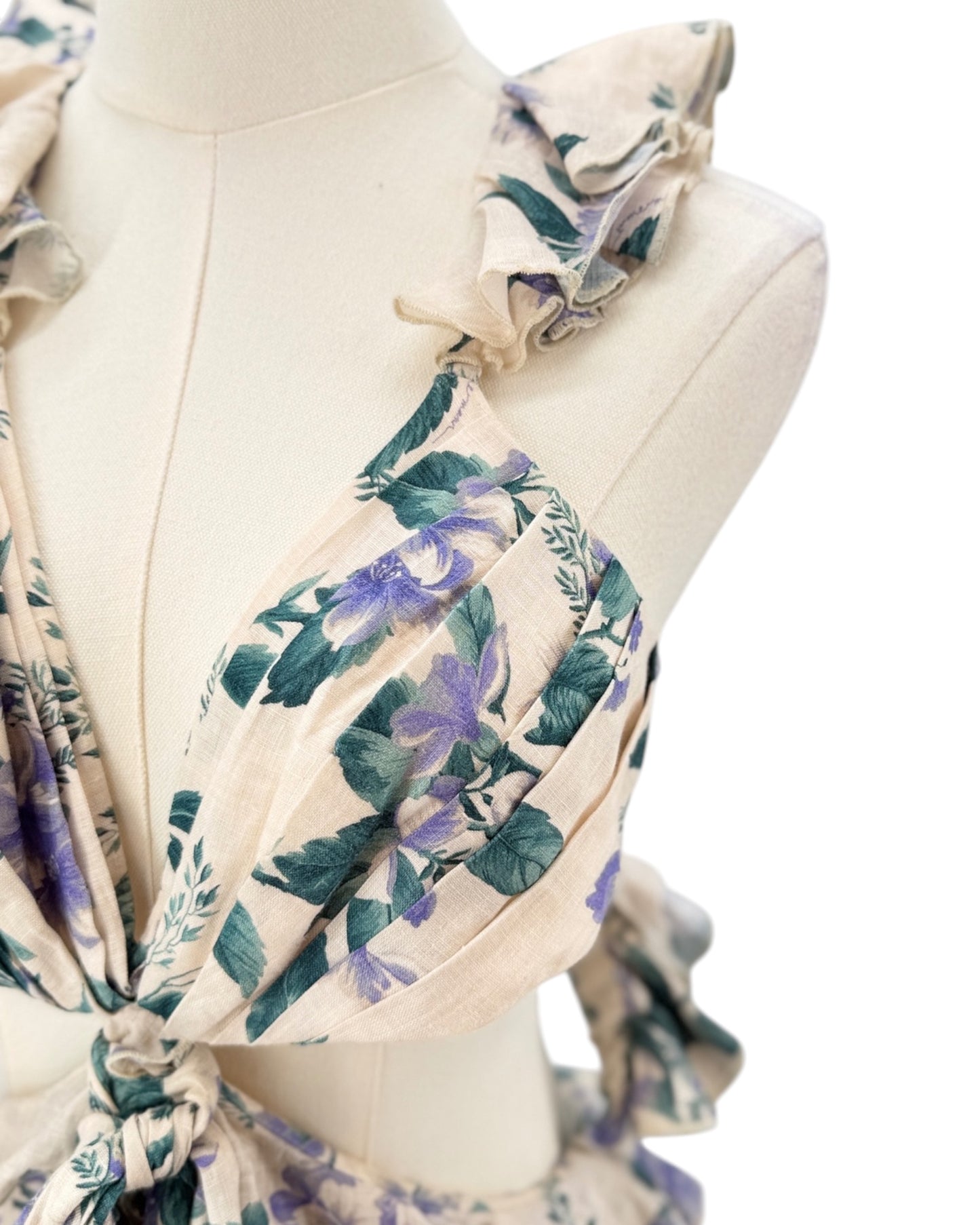 Floral patterned scarf on a mannequin with a white background