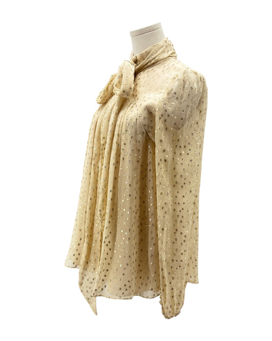 Beige top with subtle pattern on a mannequin against a white background