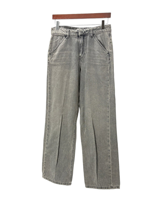 Gray jeans hanging on a wooden hanger against a white background