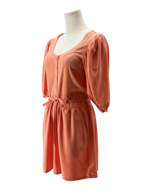Coral dress on a mannequin against a white background