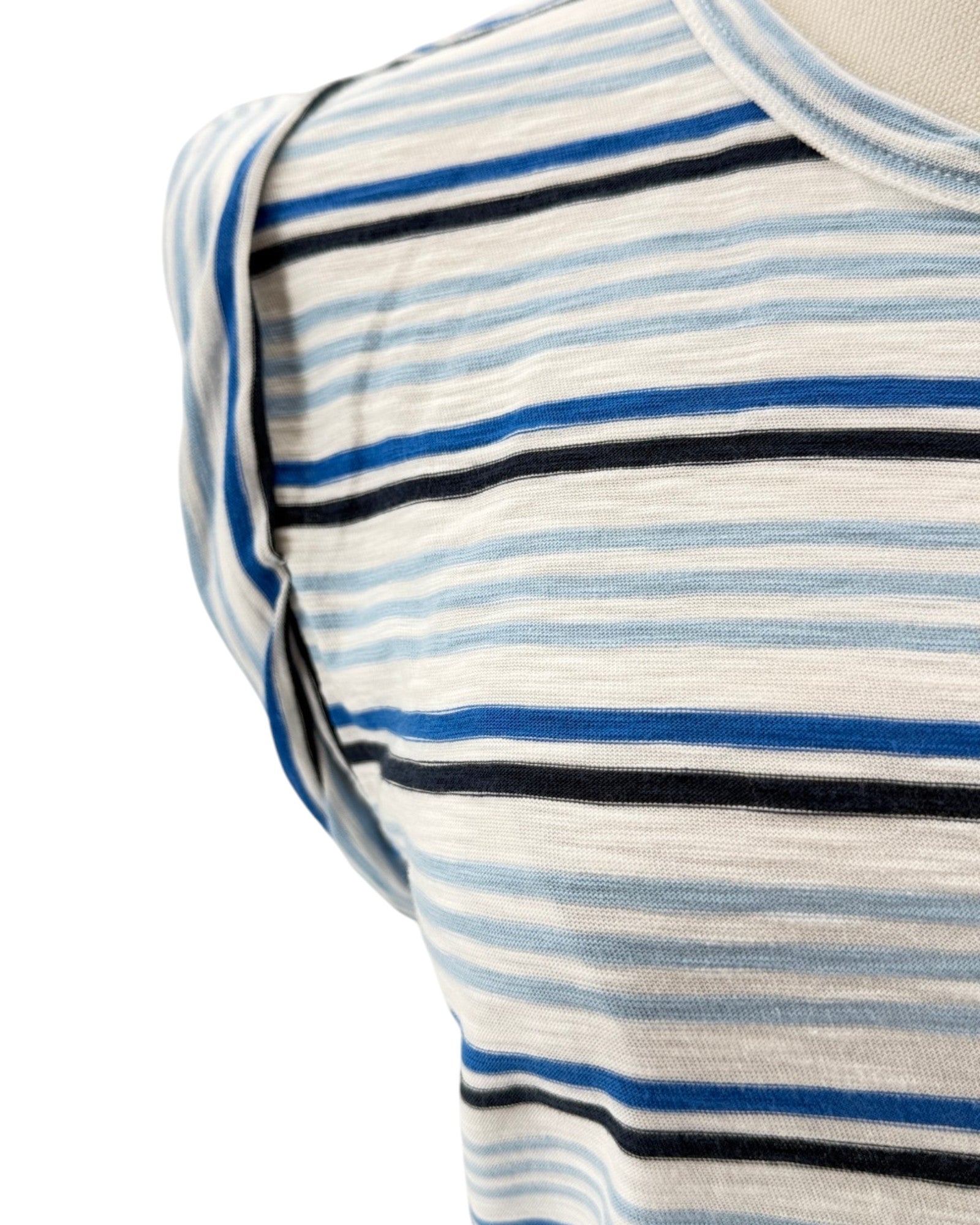 Close-up of a striped shirt with blue, black, and white horizontal lines on a white background.